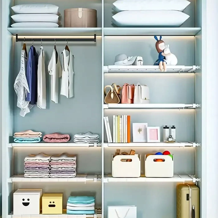 The shelf has a flat storage compartment and bars for hanging.
